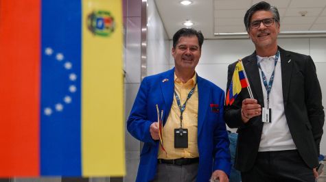 Empleados del American Airlines saludan con banderas venezolanas a los pasajeros del vuelo con destino a Caracas, en el aeropuerto Internacional de Miami en Florida. (EFE)