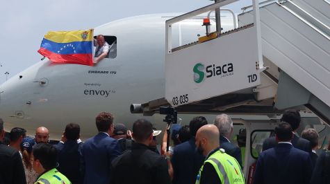 Una persona sostiene una bandera de Venezuela durante el recibimiento de un avión de American Eagle que aterrizó en el Aeropuerto Internacional Simón Bolívar de Maiquetía, Venezuela. (EFE)