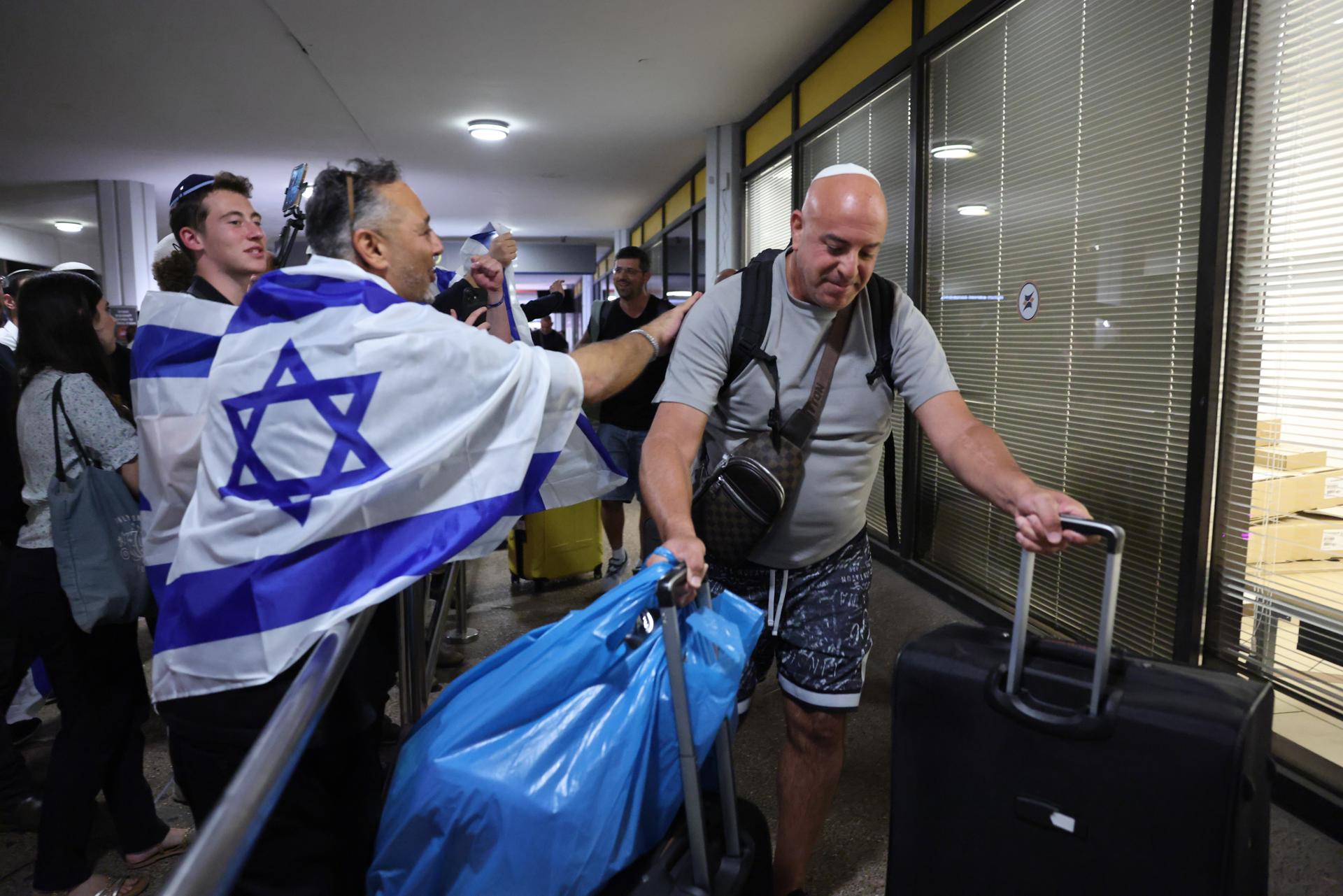En la terminal de entrada, decenas de familiares y allegados esperaban con globos, banderas israelíes y al grito de "El pueblo de Israel vive"