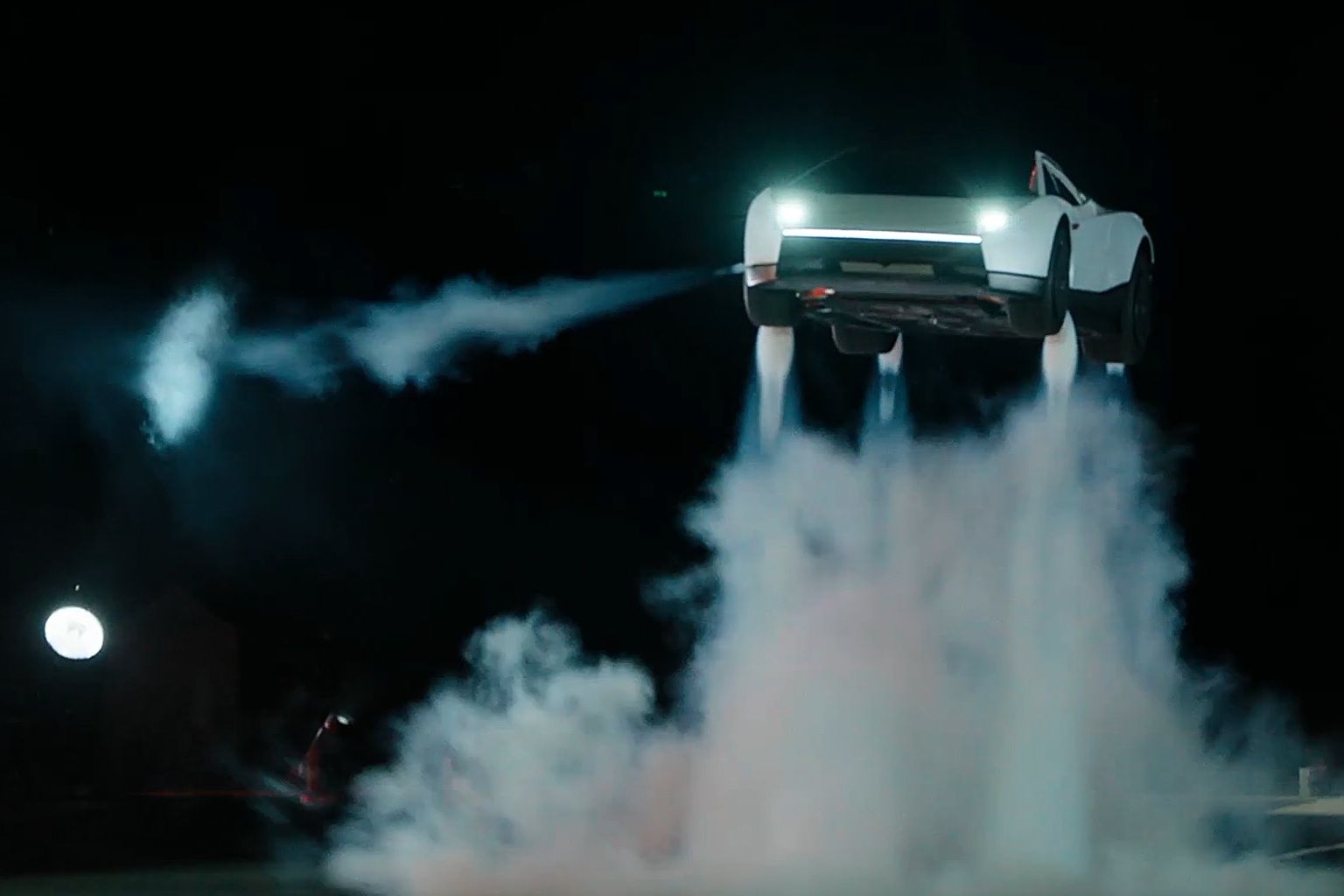 Fotografía cedida por Tesla donde aparece el prototipo de la nueva generación de su deportivo eléctrico Roadster sobrevolando invertido sobre varios autos este jueves en las instalaciones de pruebas de cohetes de SpaceX en McGregor, Texas. (EFE)